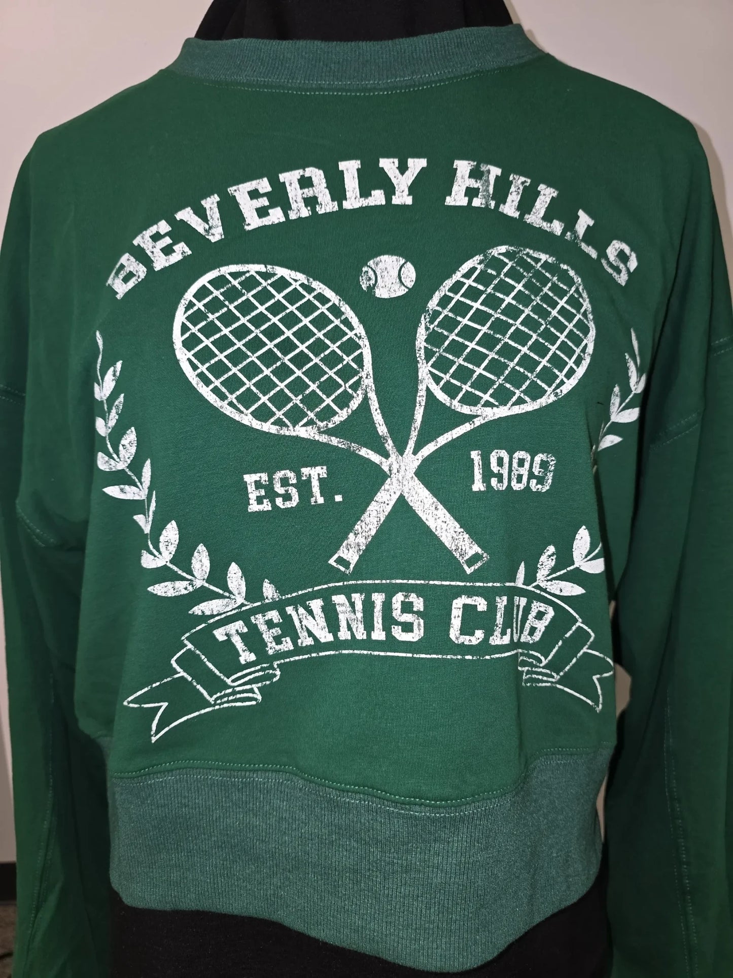 Luxury Clique forest green cropped sweatshirt with a white distressed Beverly Hills Tennis Club graphic print