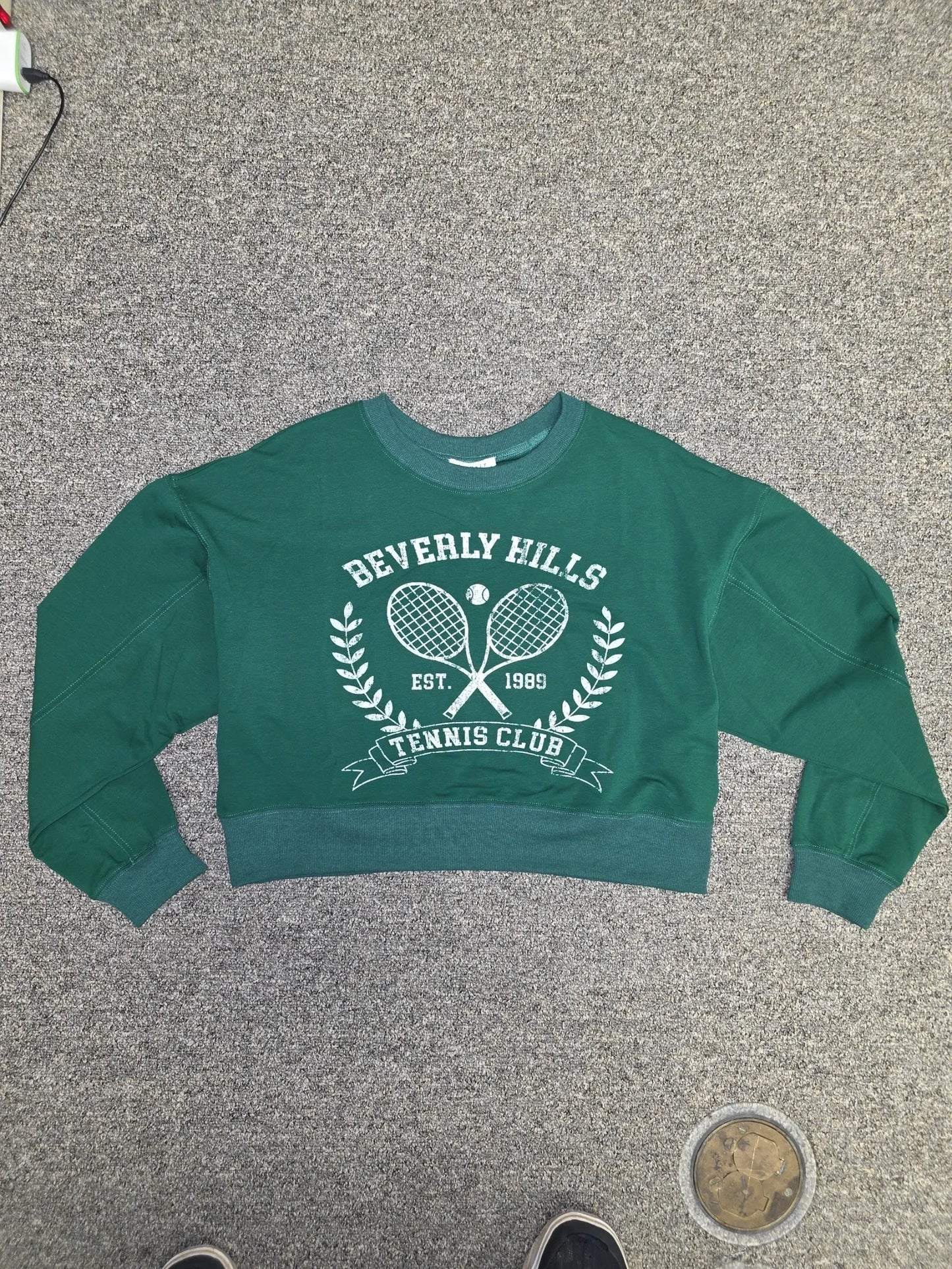 Luxury Clique forest green cropped sweatshirt with white Beverly Hills Tennis Club graphic and ribbed crew neck.
