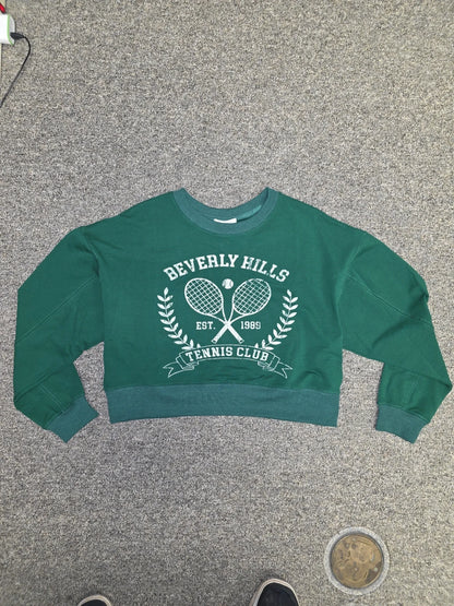 Luxury Clique forest green cropped sweatshirt with white Beverly Hills Tennis Club graphic and ribbed crew neck.