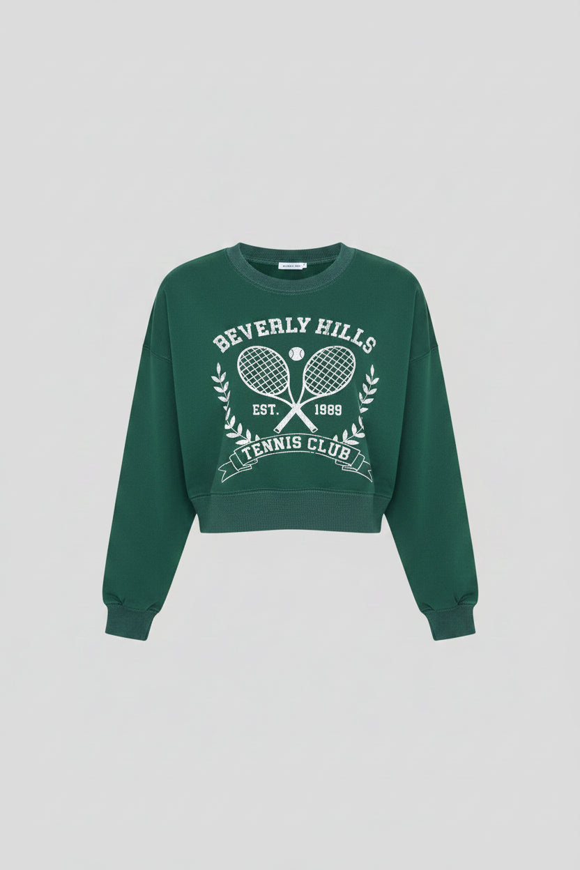 Luxury Clique forest green cropped sweatshirt with white Beverly Hills Tennis Club graphic and ribbed crew neck.